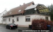 Mehrfamilienhaus (Anbau im Rohbau) und Grünland/Wiese